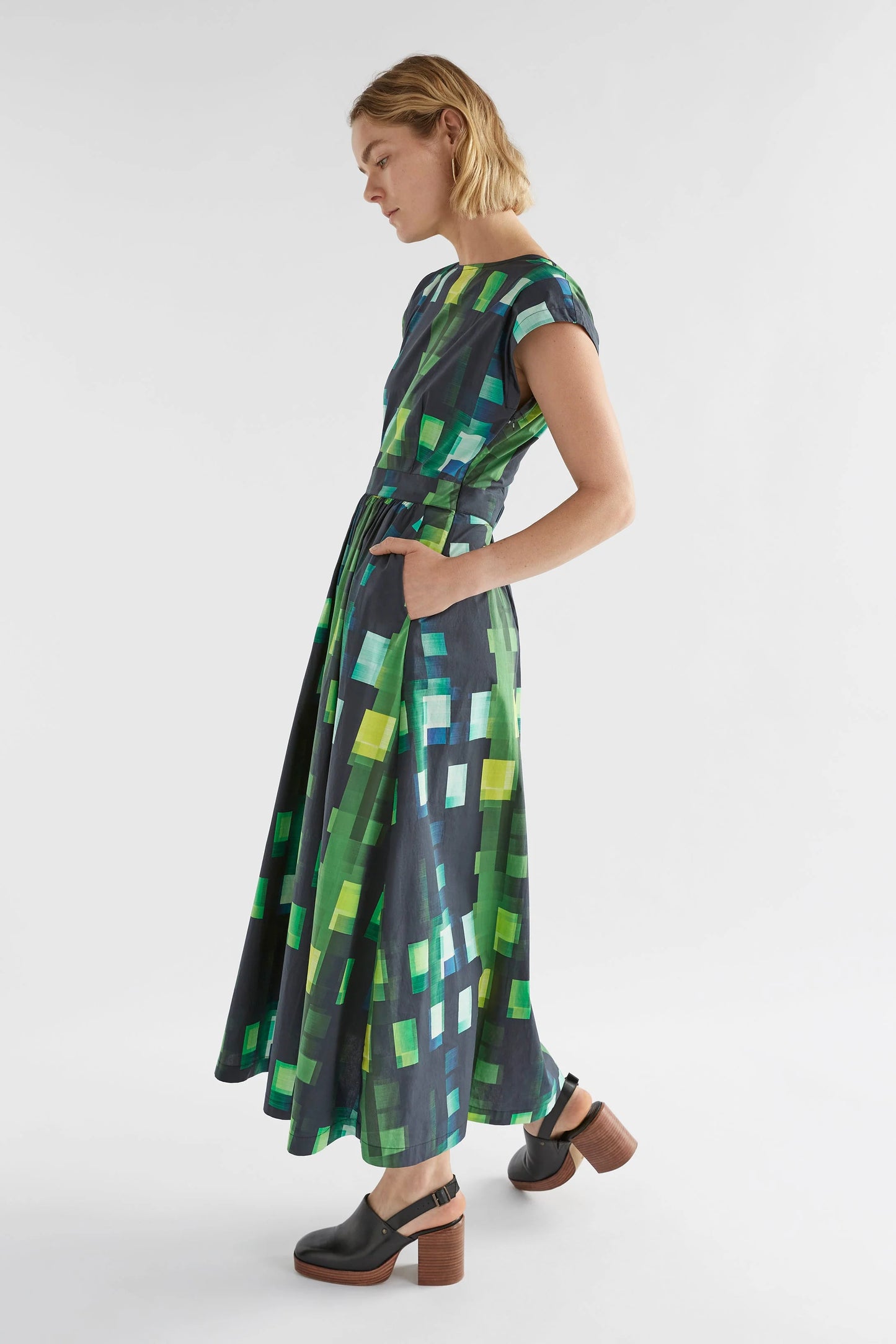 
                  
                    Indi Dress | Green Shutter Grid | Organic cotton dress with back cut out detail.  The Indi Dress is a midi length dress in a dynamic grid print with a round front neckline. 
                  
                
