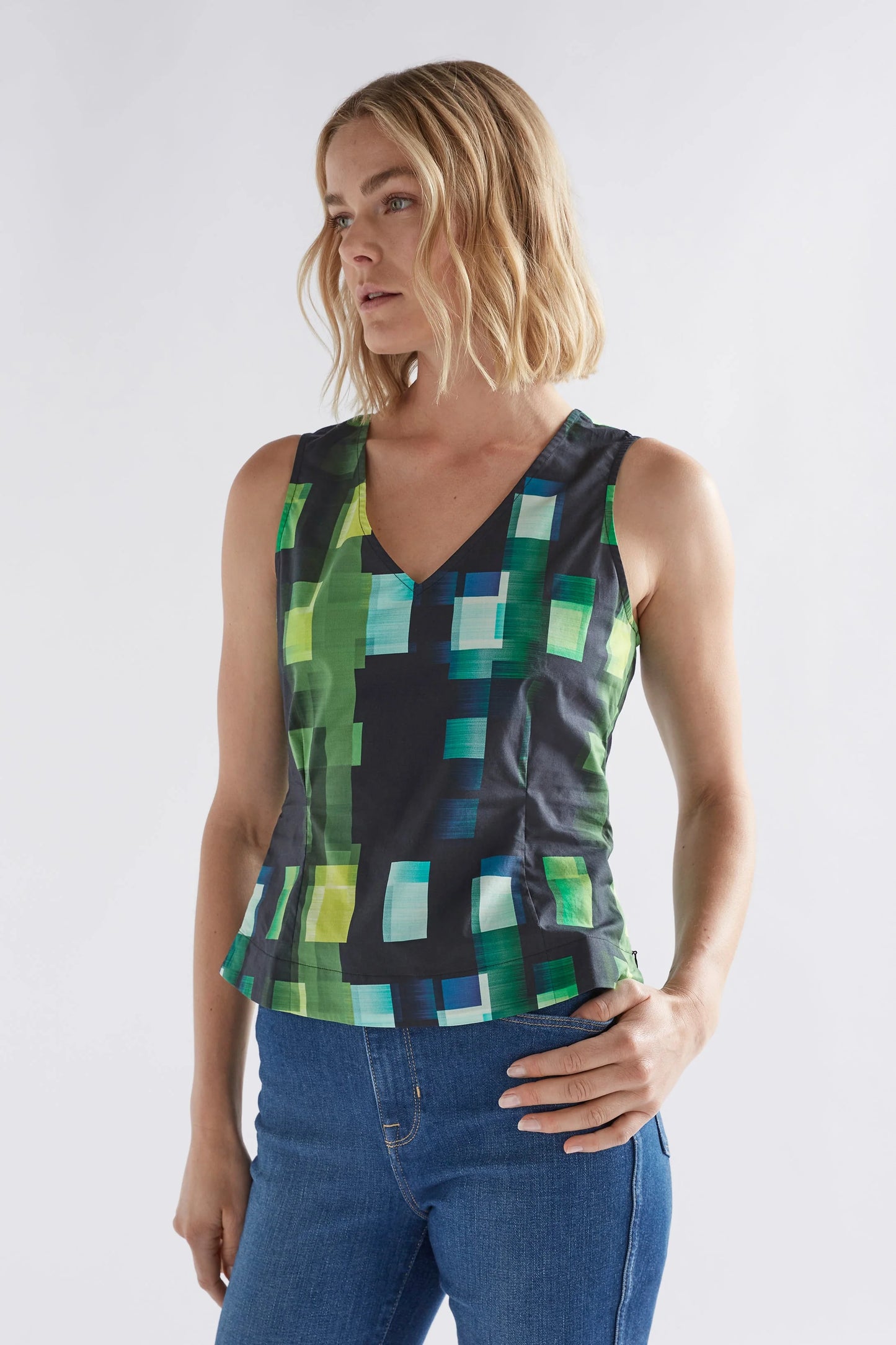 
                  
                    Indi Tank | Green Shutter Grid | Organic cotton tank with back cut out detail.  The Indi Tank is a slightly shorter length, sleeveless tank in a dynamic grid print with a V-neck.
                  
                