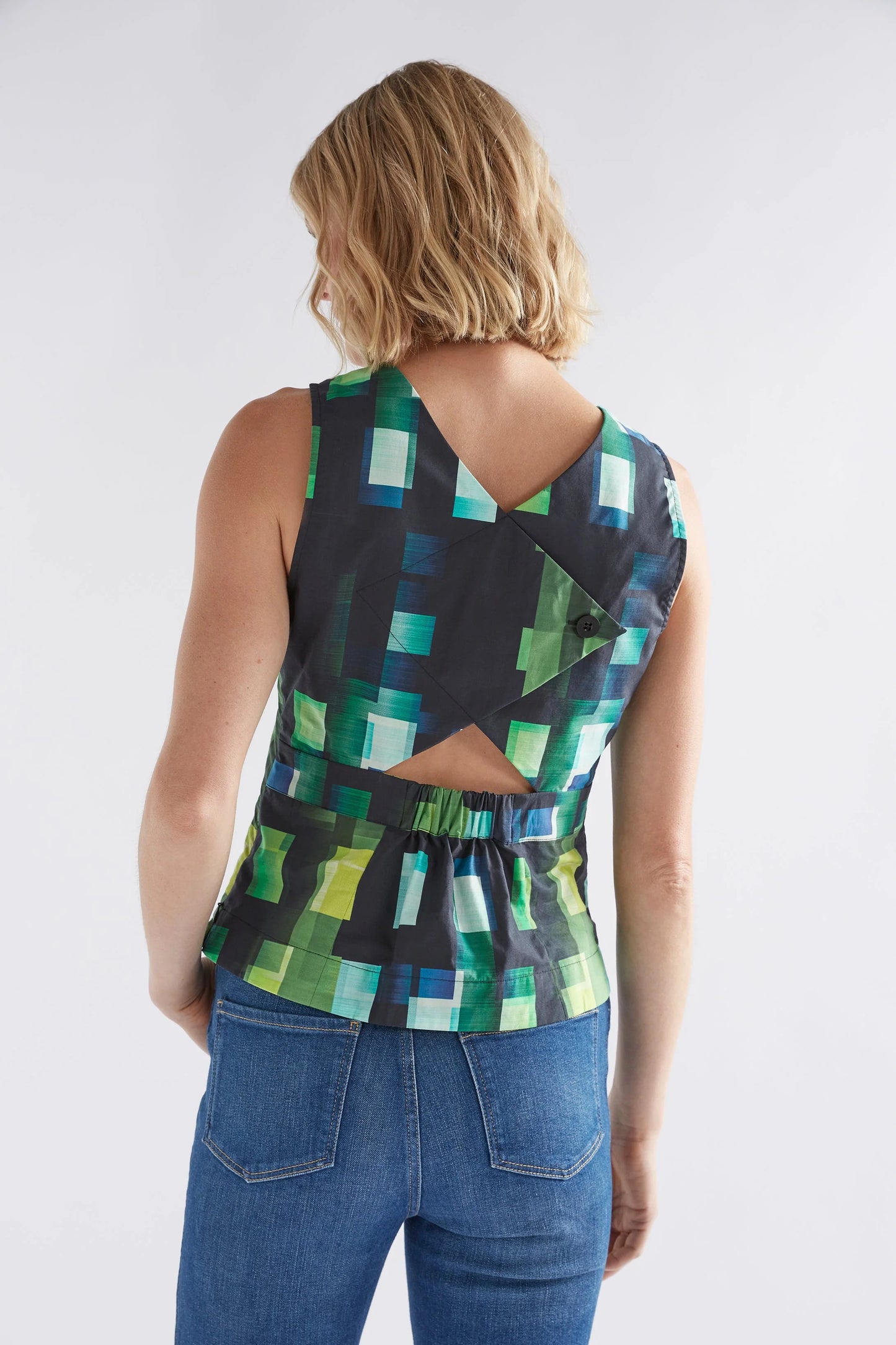
                  
                    Indi Tank | Green Shutter Grid | Organic cotton tank with back cut out detail.  The Indi Tank is a slightly shorter length, sleeveless tank in a dynamic grid print with a V-neck.
                  
                