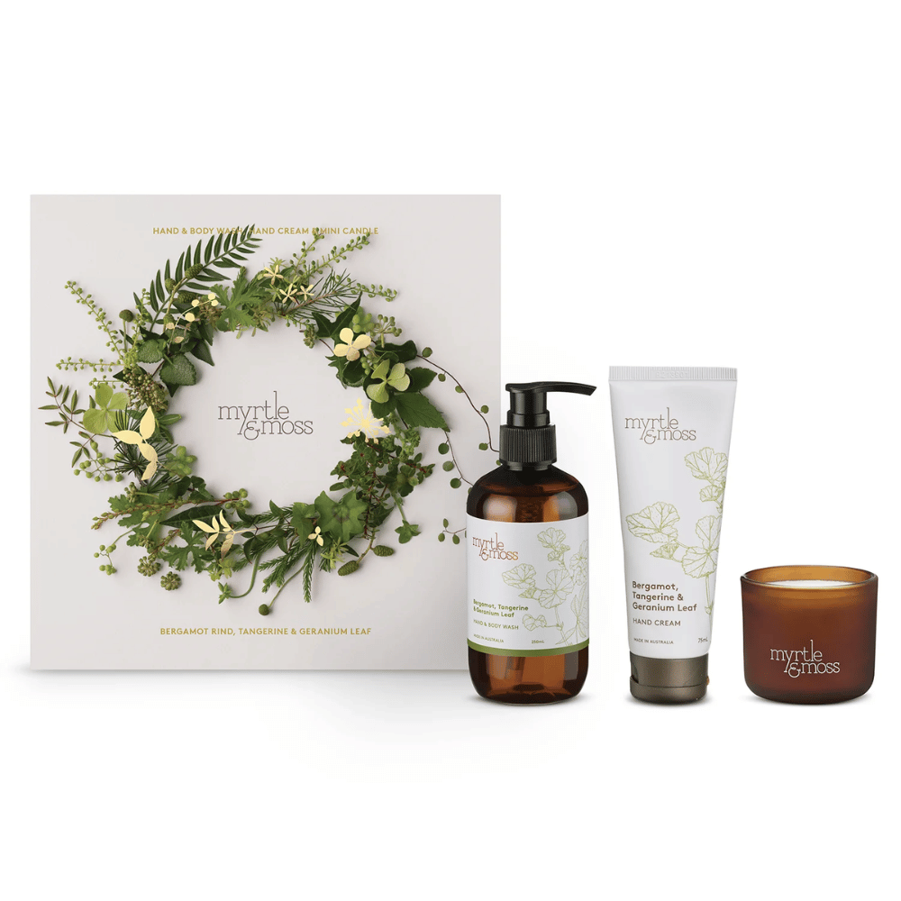 Myrtle & Moss gift set with a wreath box, bottle, tube, and candle 