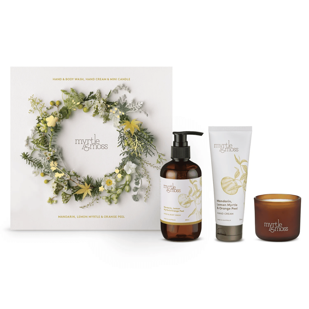 Myrtle & Moss gift set with a wreath box, bottle, tube, and candle 